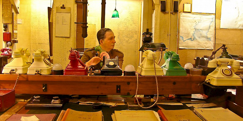 A mannequin mans the bank of phones in the Cabinet War Rooms (Photo Â© by Reid Bramblett)