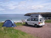 A camper and a tent overlooking a killer whale migration route at Sango Sands Campsite, Durness, Sutherland, Scotland