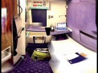 A wide angle shot of a Caledonian Sleeper single berth cabin