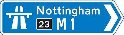 A motorway sign (the yellow-on-black number is the junction/exit number)