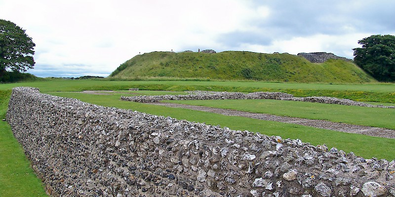The remains of some walls, with the central hill stop which once sat the castle in the background (Photo Â© Reid Bramblett)