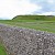 The remains of some walls, with the central hill stop which once sat the castle in the background, Old Sarum, Salisbury and Stonehenge (Photo Â© Reid Bramblett)